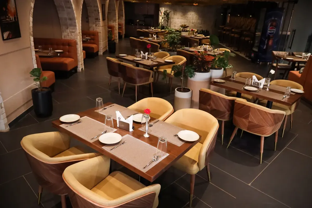 Brick and Brew in-house dining restaurant interior with stylish table settings at Radiant Vista